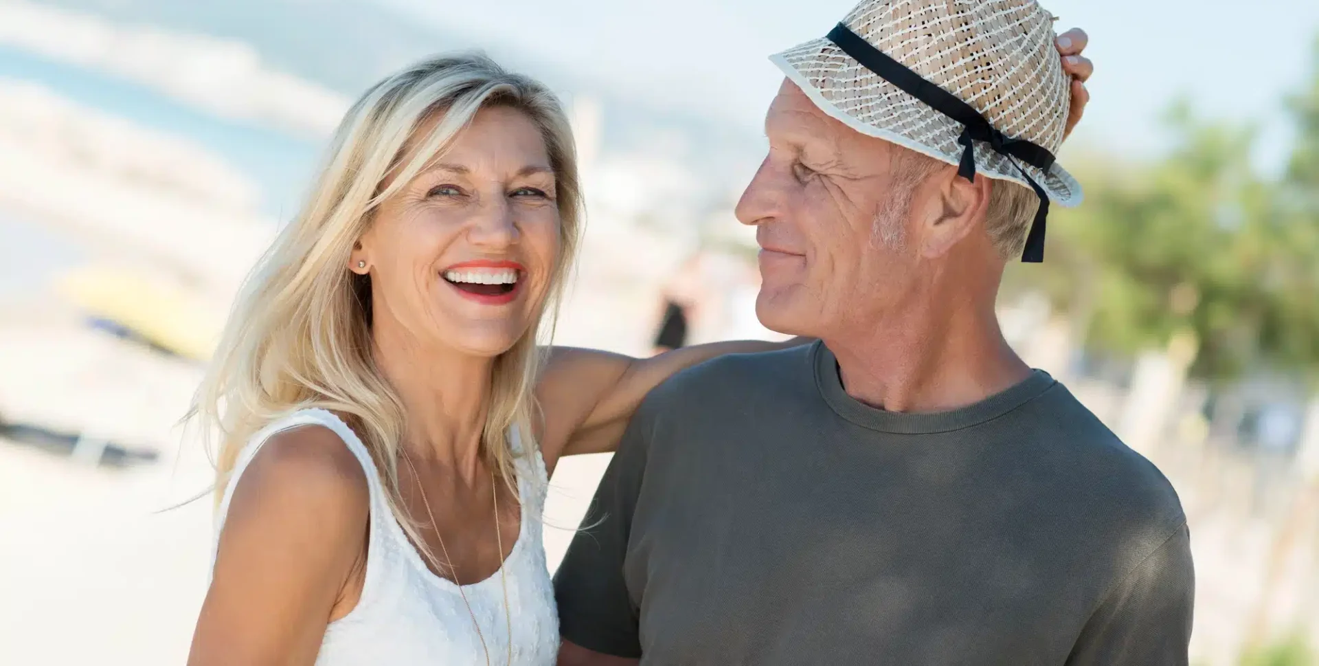 mature attractive couple smiling on the beach
